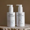 Premium bundle featuring cadó Leave-in Conditioner for adults and the 'For Little Curls' edition for kids on a marble display.