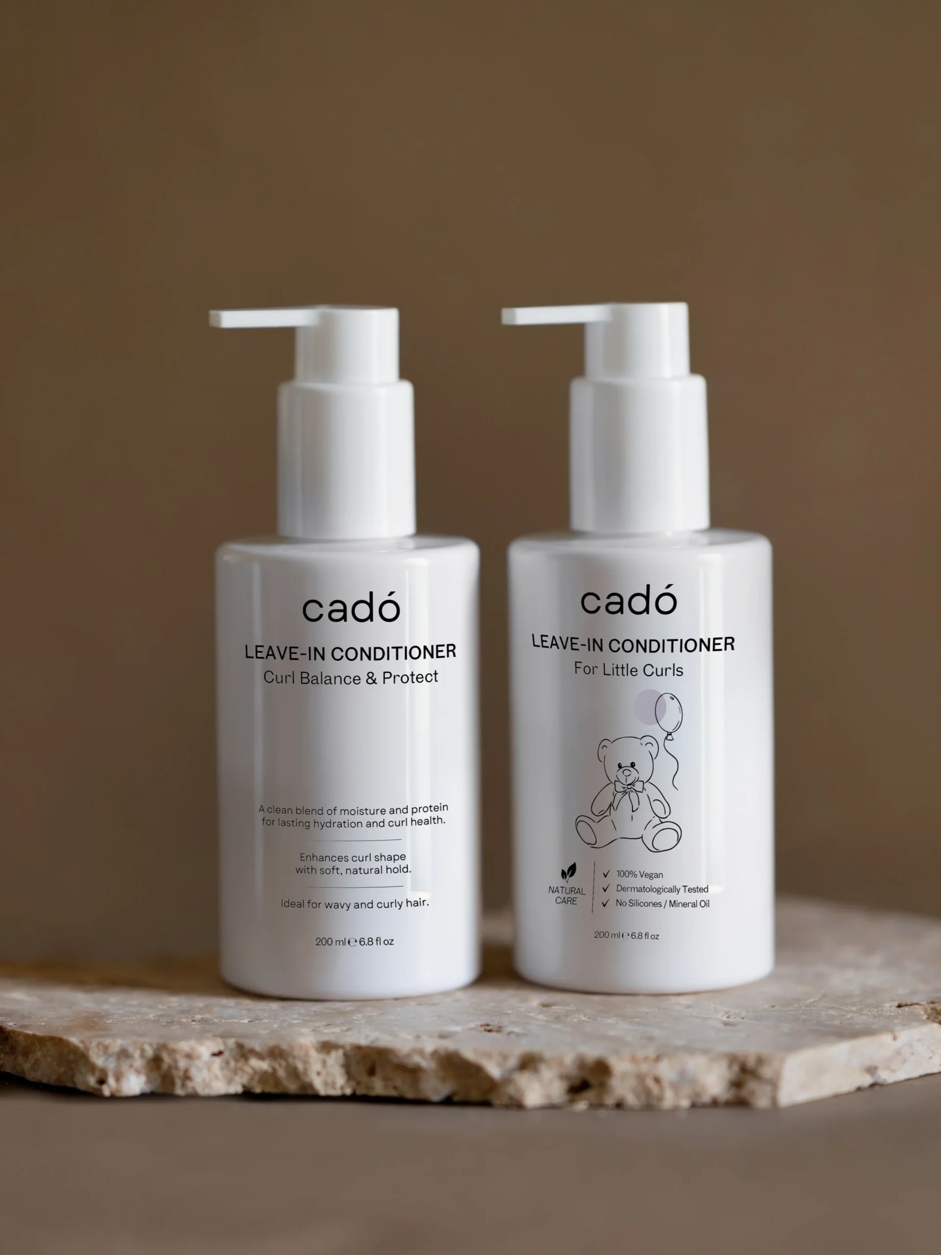 Premium bundle featuring cadó Leave-in Conditioner for adults and the 'For Little Curls' edition for kids on a marble display.