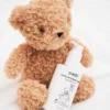 Gentle leave-in conditioner for kids with curly hair, featuring the cadó 'For Little Curls' bottle next to a teddy bear.