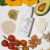 Natural ingredients for kids' curly hair products including avocado, sunflower, and almonds, surrounding the cadó 'For Little Curls' conditioner.