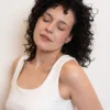 Woman showcasing soft, hydrated, and frizz-free curls after using cadó professional leave-in conditioner.