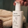 Gentle creamy texture of cadó For Little Curls Leave-in Conditioner being dispensed for easy detangling and hydration.