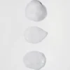 Comparison of cadó product textures showing the airy styling foam and the rich, creamy leave-in conditioner consistency.