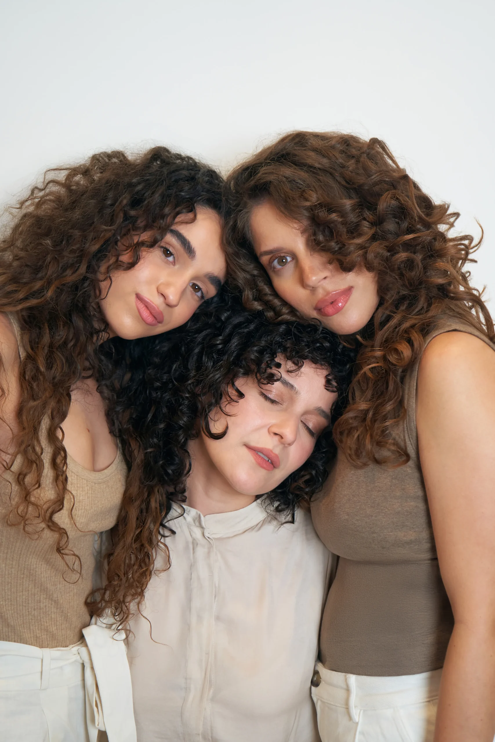 Diverse curly hair models showcasing natural results from the cadó ritual, mobile-friendly high-resolution portrait.